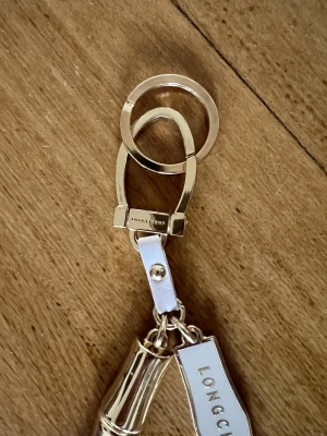 Longchamp Schlüsselanhänger gold | LOOP-Marktplatz